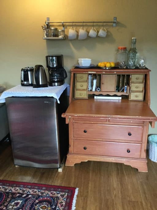 The refrigerator and desk contain all you need for coffee, tea and a light breakfast. The desk can also be a work space.