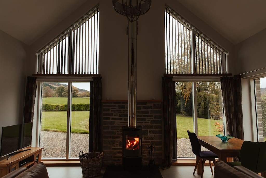 Open plan living area with wood burning stove.