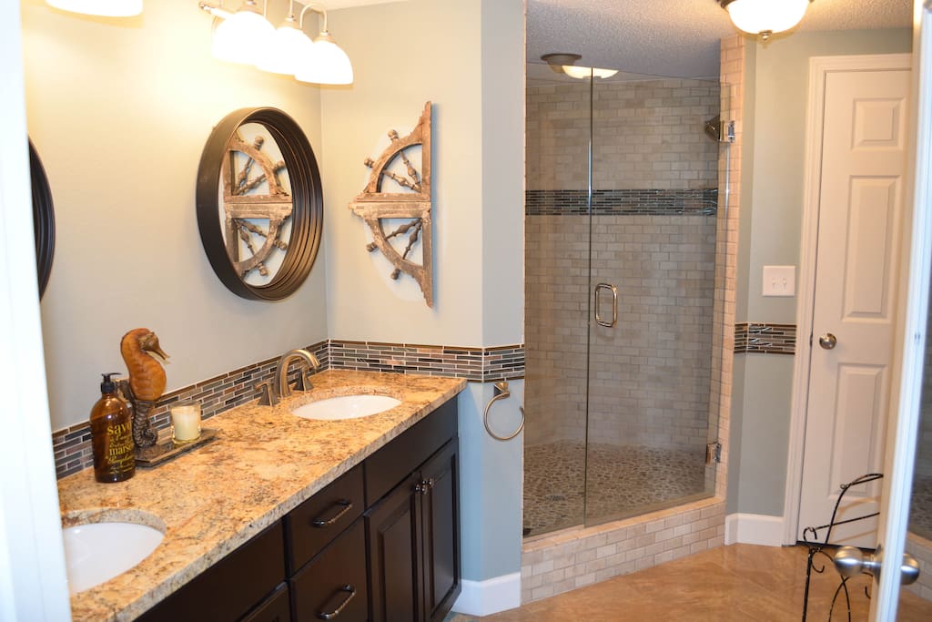 Master bathroom with walk-in shower and nice walk-in closet