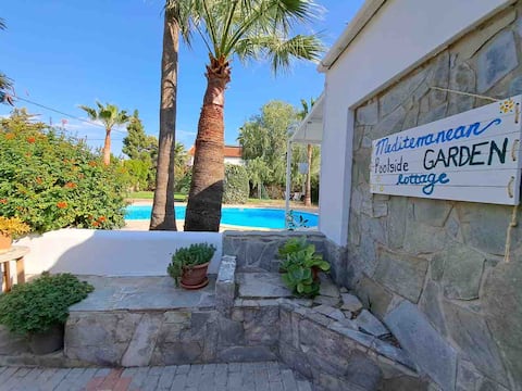 Mediterranean poolside garden cottage