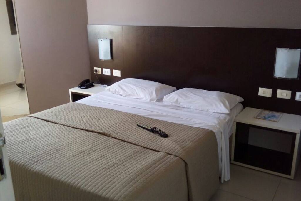 Cama de casal e controles na cabeceira de luz e televisão. Todas as tomadas são 220V/Double bed and additional twin box bed. All outlets are 220V.