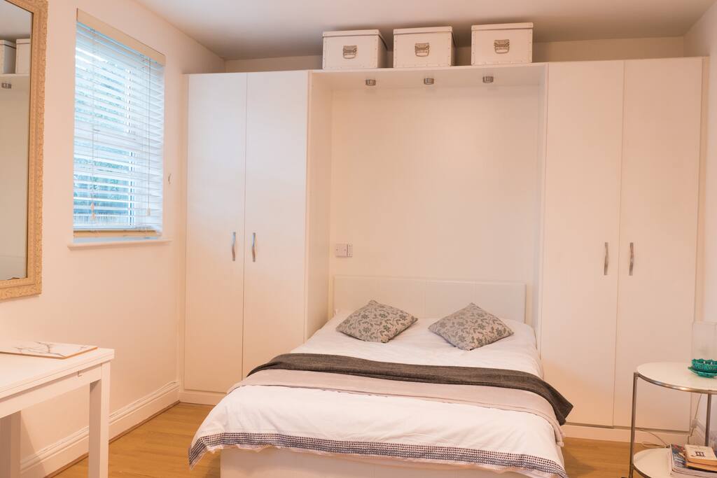The bed area, which is opposite to the living area. This is a studio apartment.
