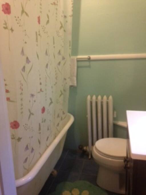 Cozy, private bathroom with bathtub for warm baths