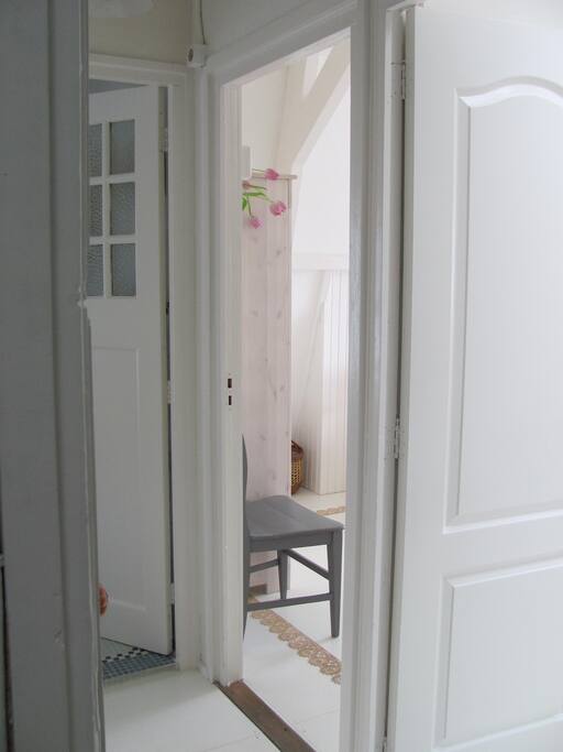 two rooms, a corridor, and a large bathroom