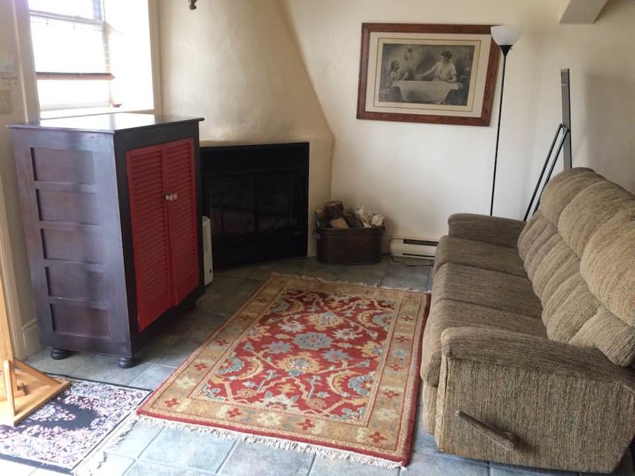 Living room with fireplace and reclining sofa