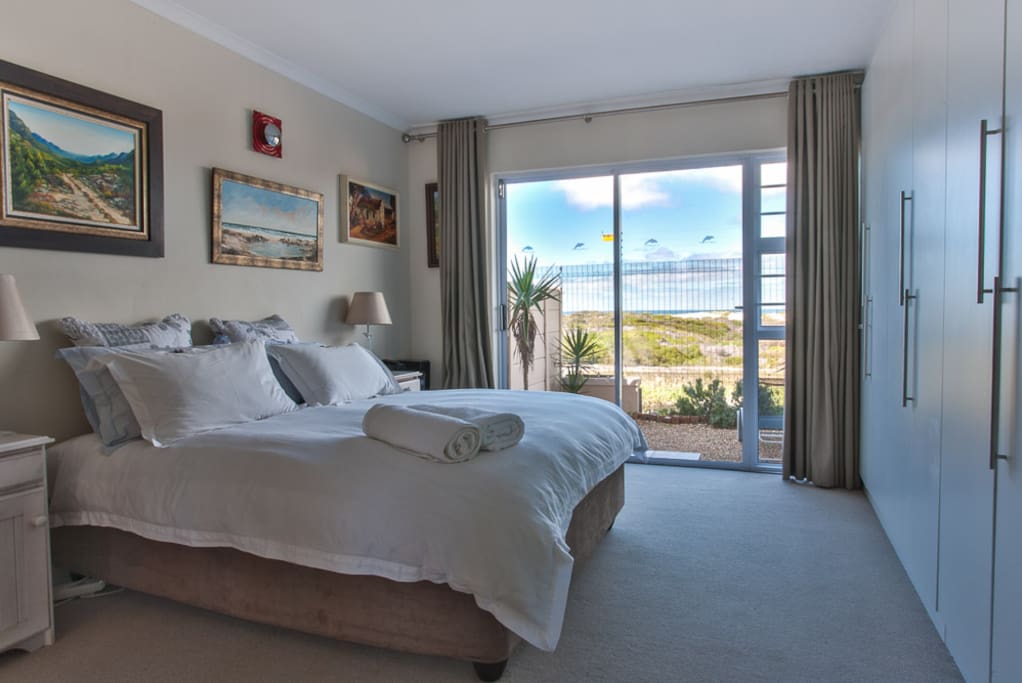 Main bedroom, en suite bathroom, sliding door leading onto small garden, sea facing