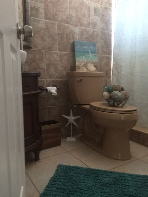 Bathroom with shower. Bathrooms are boring but Golf cart rentals are fun reserve yours today!