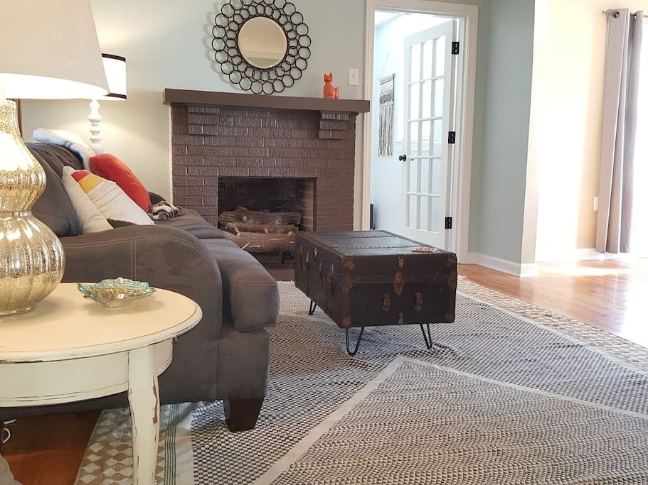 Enjoy the open living room with gas fireplace. The glass door leads to a room with a twin bed.