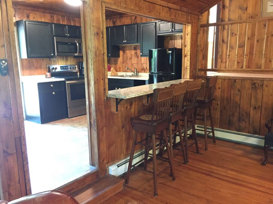 Spacious kitchen with bar area. Kitchen opens to rear patio through sliding doors.