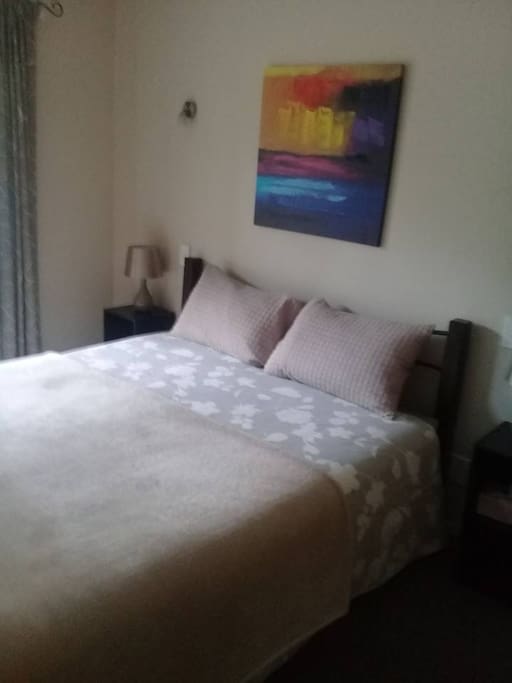 Large closet with hangers, extra blankets, sheets, and towels
