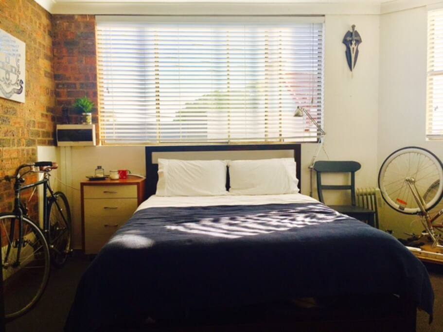 Very Large Sunny room with Wrapped around window overlooking main road
