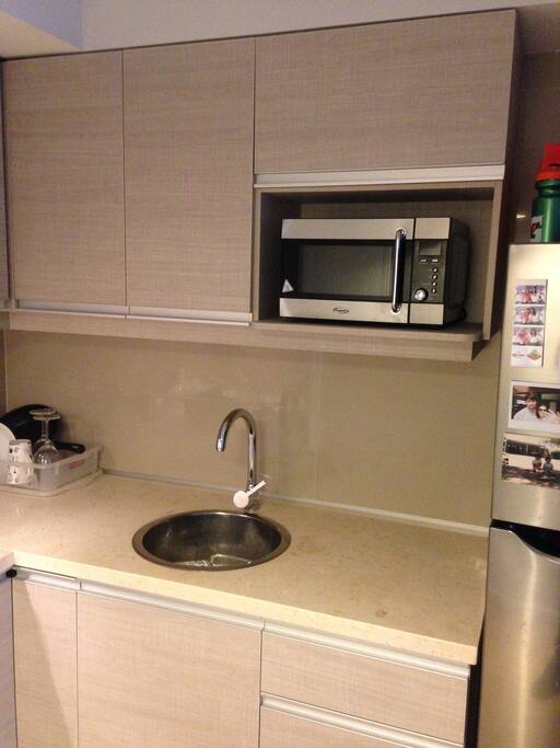 Kitchenette includes microwave, refrigerator, and electric stove