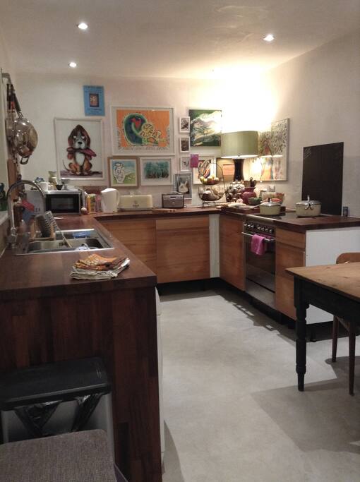 Kitchen with small table and door to back garden and downstairs bathroom.