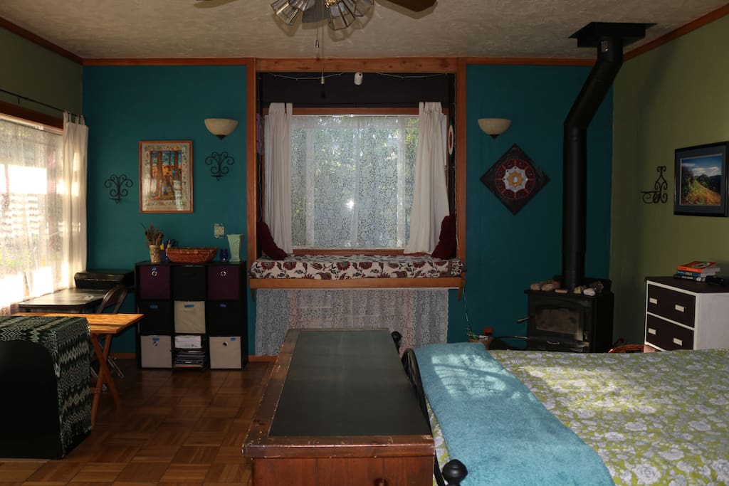 Bedroom #1 includes a wood stove, a window seat, comfy queen bed.