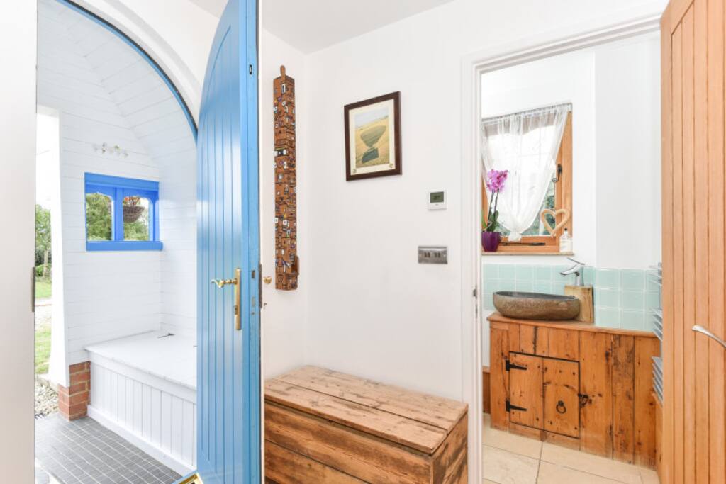 Porch, entrance hall, and a peek at the downstairs bathroom