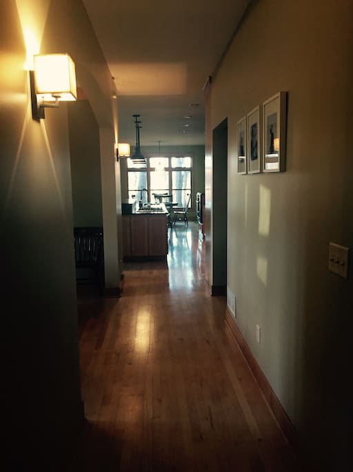 Hallway from main entry leads to kitchen, dining, library & screen porch