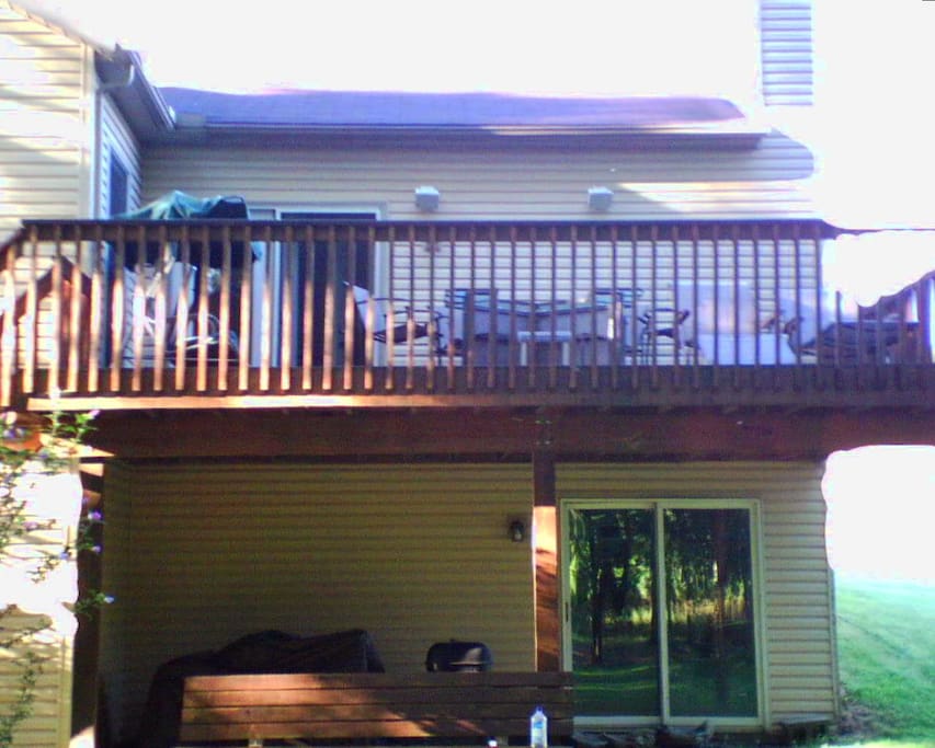 Rear View Showing Ground Level Walk-In Storage Space & Living Level Balcony