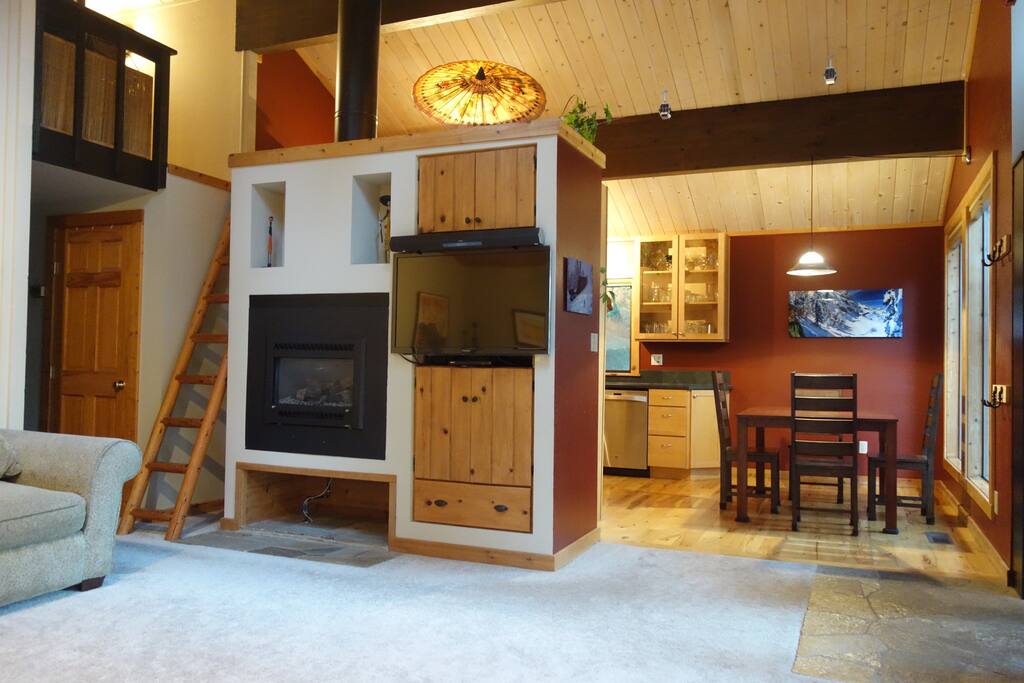 Living room, dining area and ladder to loft with queen bad