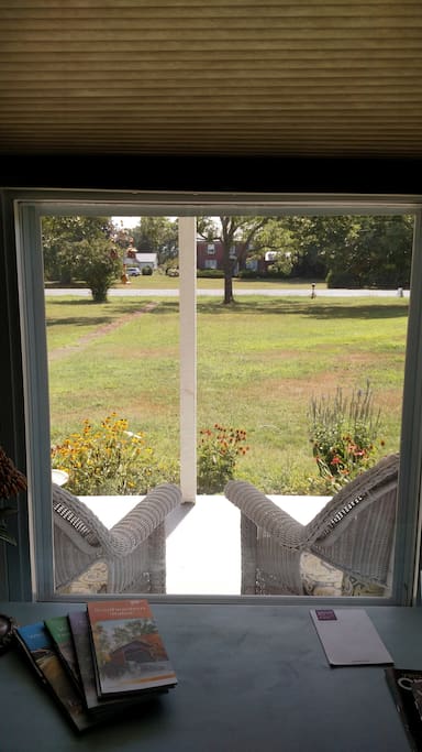 A view from the desk, looking out one of the two windows in the room; seats outside are perfect for enjoying a glass of wine.
