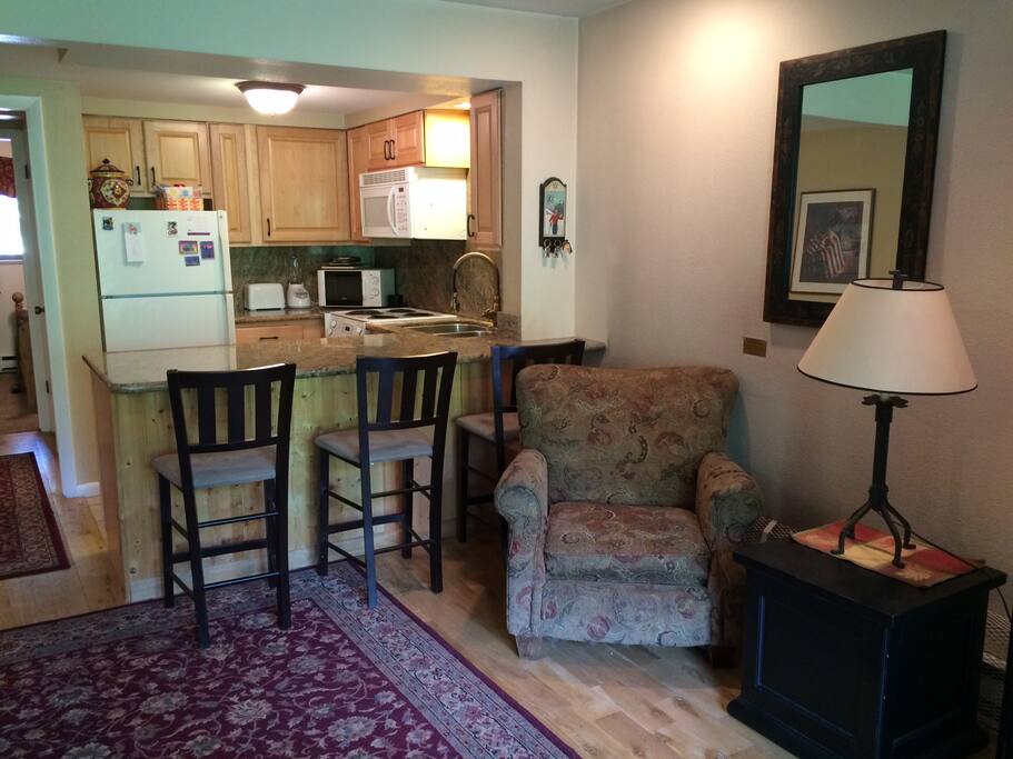 Living room and kitchen with slab granite