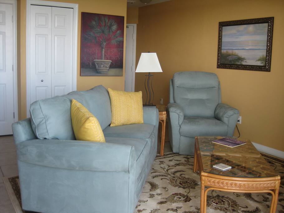 Living room with sleeper sofa and electric recliner.