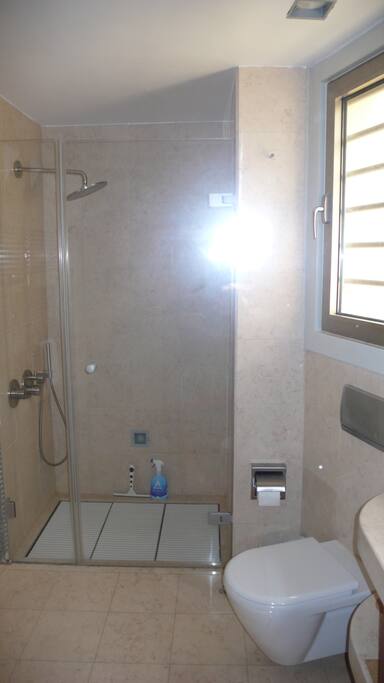 private marbled bathroom with marbled shower