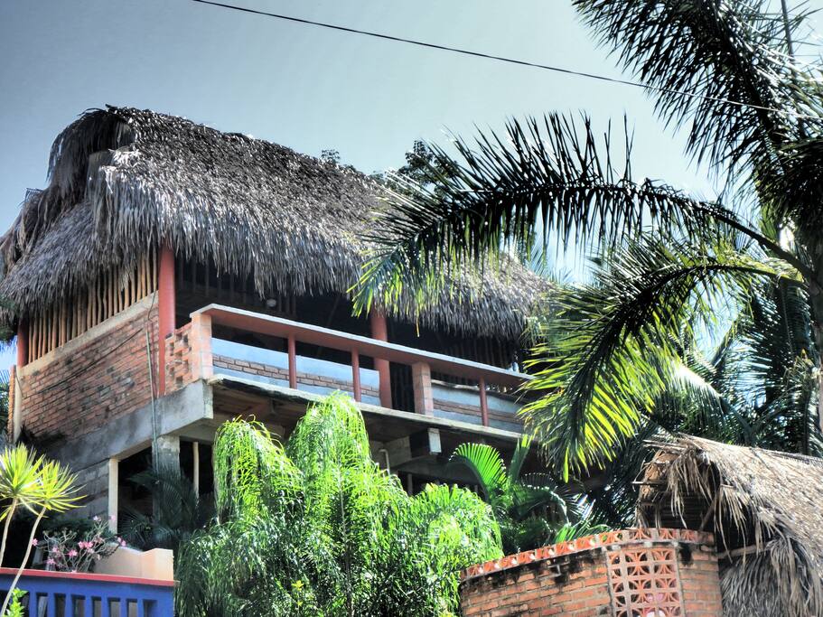 the Treehouse sits high above the property, thatched roof, and open air keeps it nice and cool.