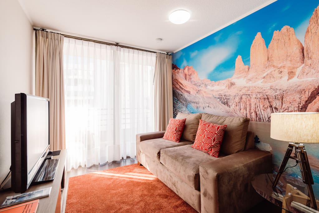 View of the Living room, wall paper is a view of "Torres del Paine" in the South of the country during the summer season