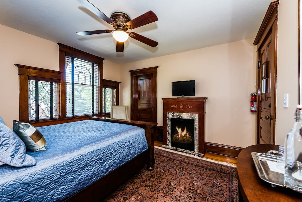 Warm inviting decor with a hand-knotted silk rug, comfortable furnishings, glass-tile hearth, walk-in closet, TV and original artworks.