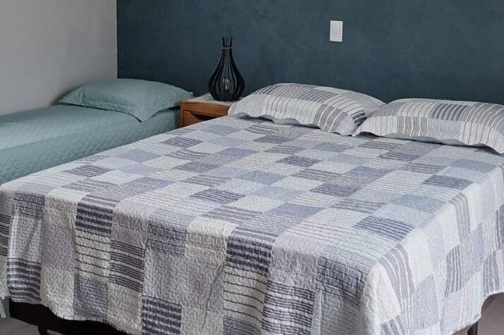 SUITE: with a king bed and a single bed. Ideal for 3 people. 
Cabinet and ceiling fans. Natural and super ventilated air entrance.