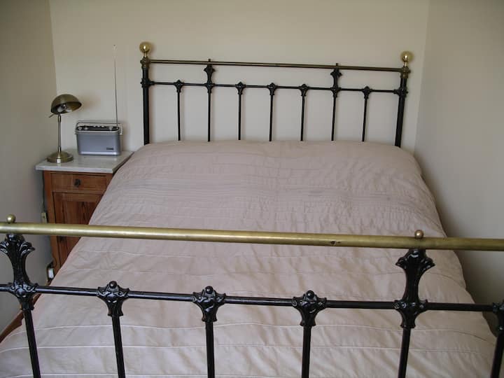 Antique queen size bed in bedroom 1.
