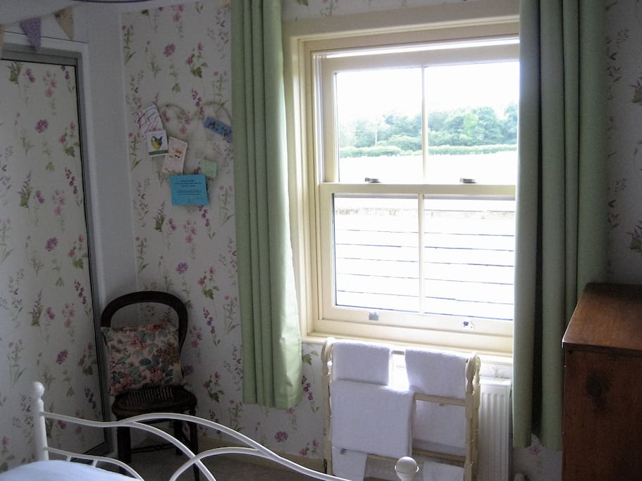 Cozy guest bedroom with south-west facing view from window photo 2