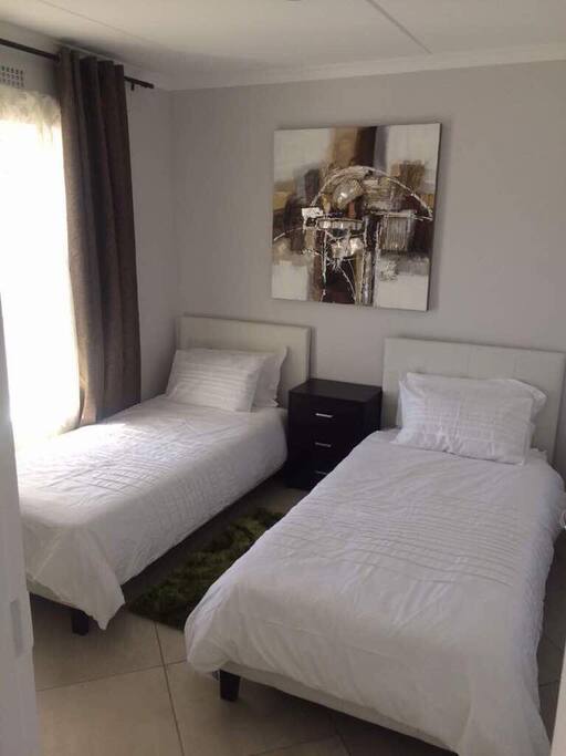 Second bedroom furnished with 2 single beds.