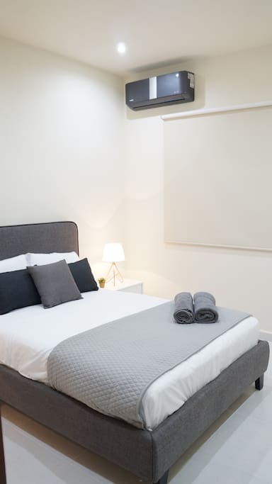 Second room with private bathroom, big closet, air conditioner, bed lamps, double size bed and towels