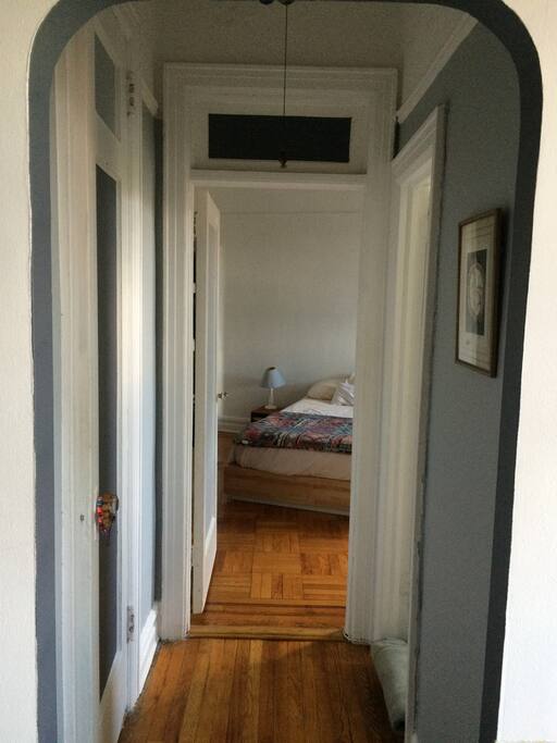 Hallway leading into bedroom from living room - the bathroom is off to the right and a huge closet on the left