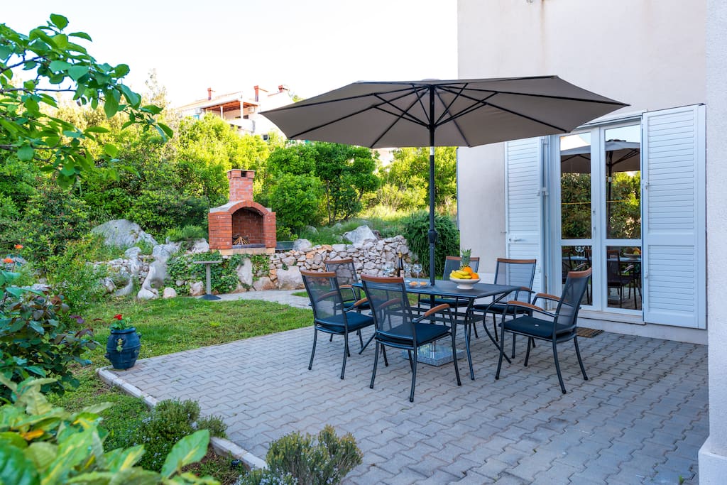 Outdoor area and BBQ in the background