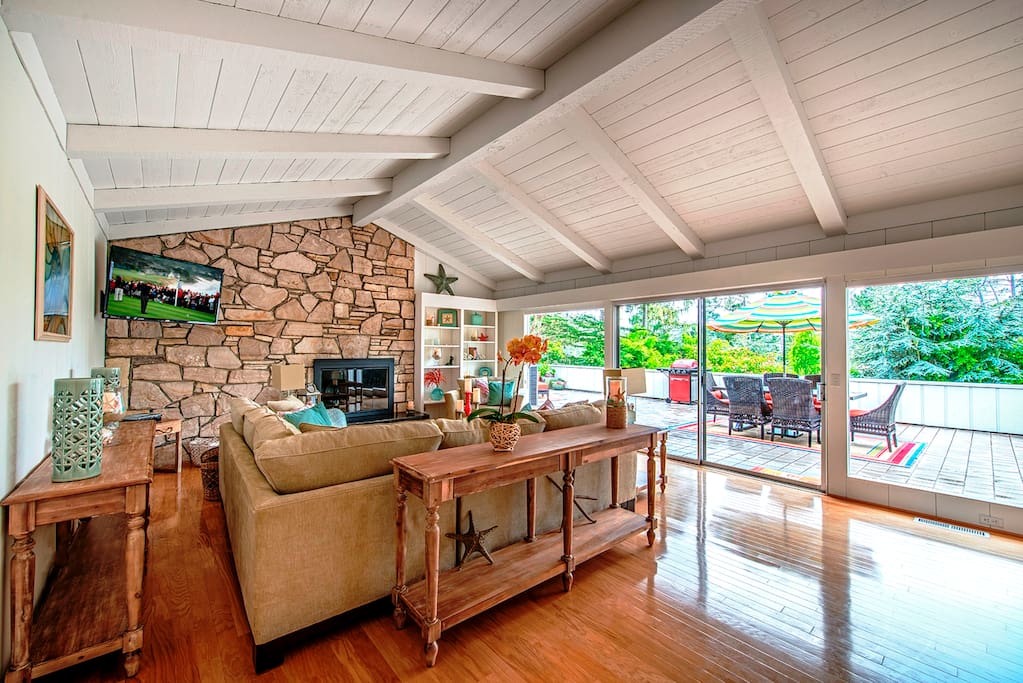 Light filled living room with HDTV, fireplace and access to deck.