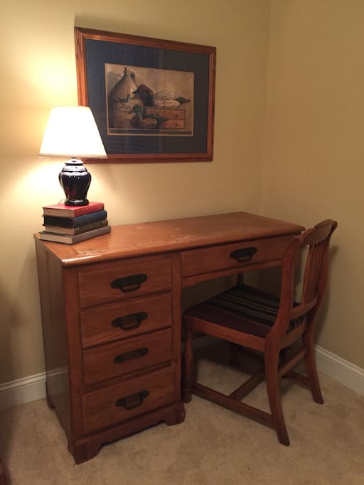 Desk with lamp, chair.
