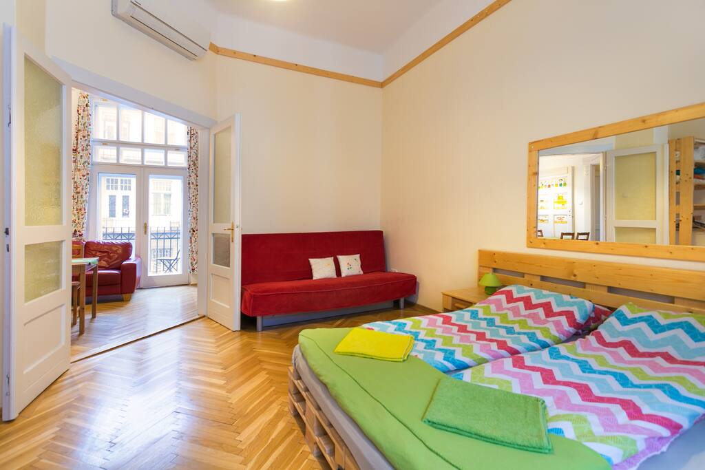 Bedroom 21 m2 with a double bed (160x200) and a sofa bed (140x200). As furnishing there are also a desk with a chair, and a smaller and a bigger wardrobe.