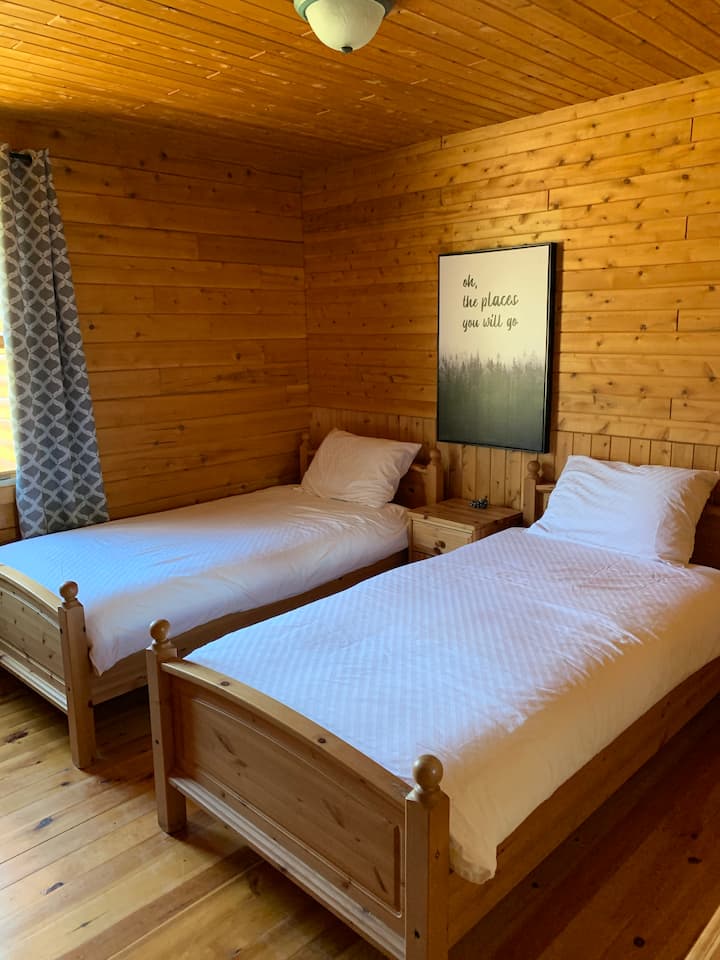 Resort View Bedroom #2 - Two single beds with private bathroom, walk-in closet, dresser and large window where can enjoy the morning sunshine. Also has black out curtains for those who want to sleep in. 