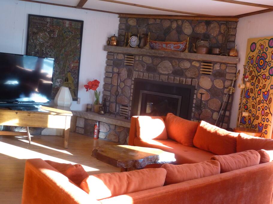 Pull out couch on one side of this large family room with 51 inch TV with Netflix, and on the other side a Queen bed. Top of the line Propane Fireplace with remote control to keep the room exactly the way you want it. Large French doors open to a patio with barbecue, tables and chairs, and a fenced in yard for dogs. This family room can be curtained off for privacy.