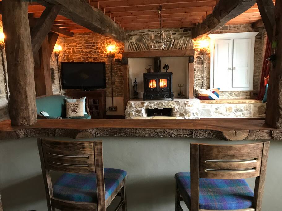 A view straight across the bar into the lounge with the large central wood-burner.