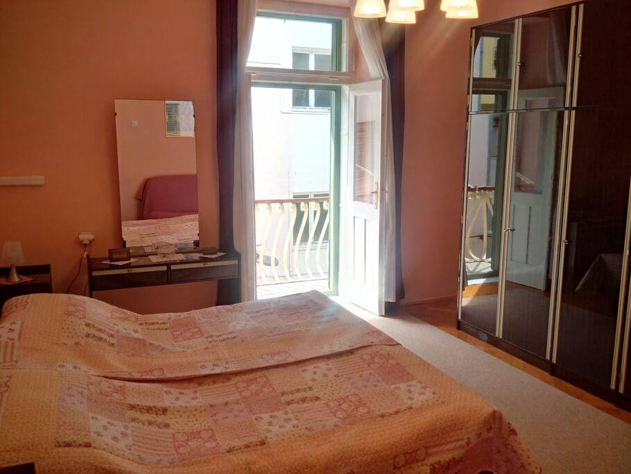 A spacious bedroom with balcony