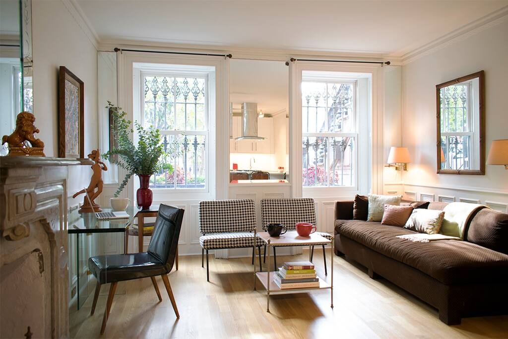 Vintage Knoll houndstooth slipper chairs, a down-filled, tuxedo-style sofa on new oak hardwood floors.