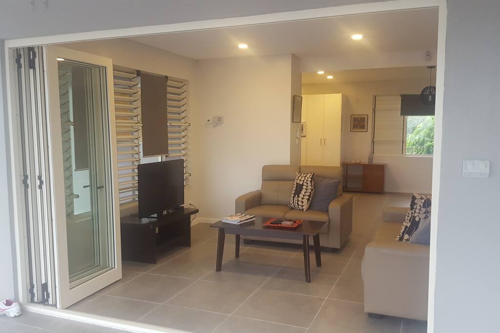 Lounge area with wide sliding door that open to a verandah