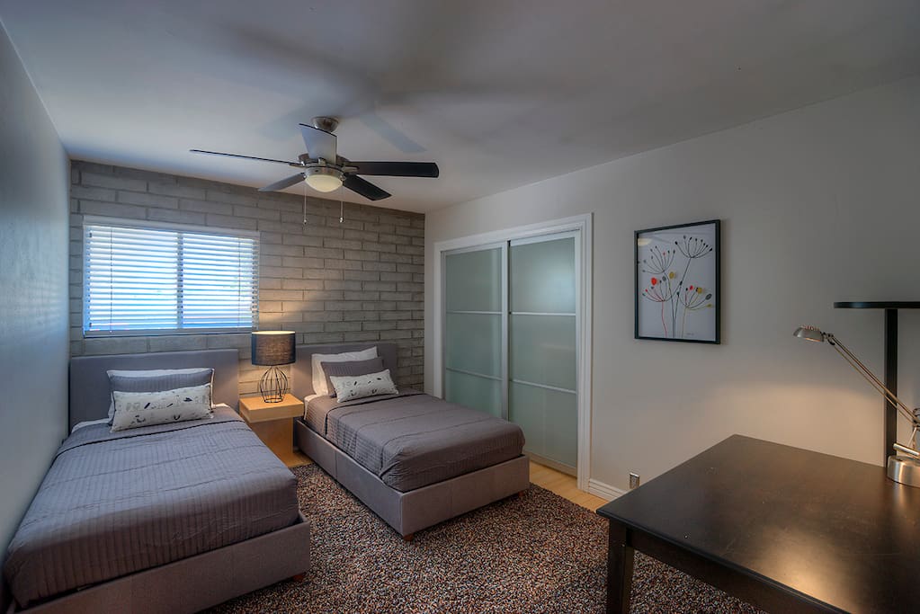 Guest room has two twin beds and a desk along with great closet space w/ drawers