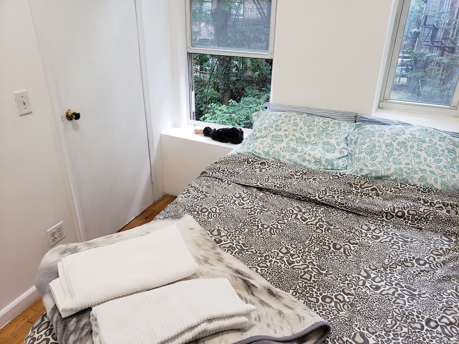 Queen size bed comes with clean linens and towels.