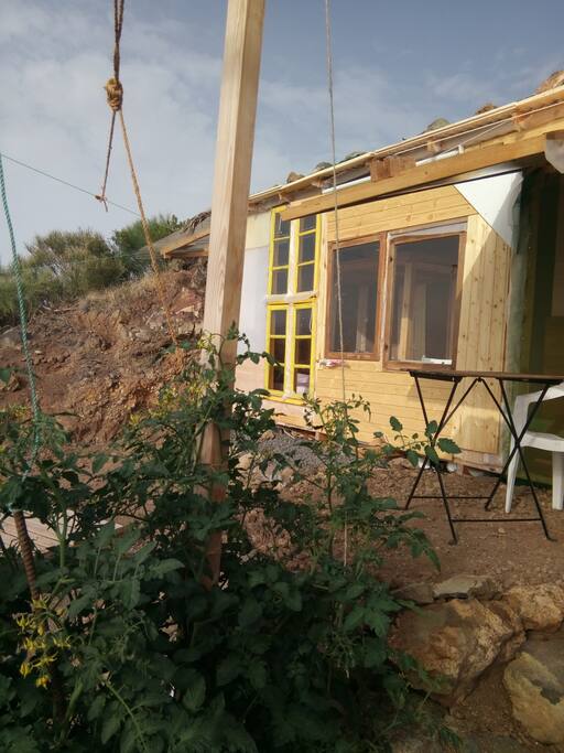 The lodge from the outside, with the little shaded terrace directly beside the entrance of the lodge.
