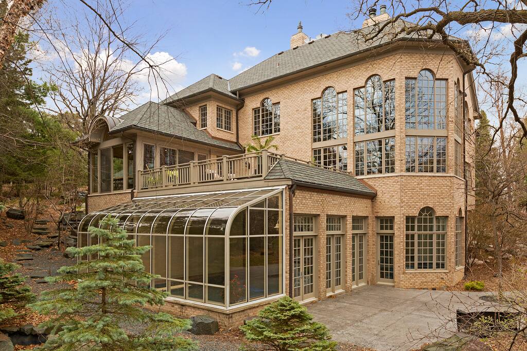 Property features all-brick exterior and ornate landscaping including trap rock waterfall.