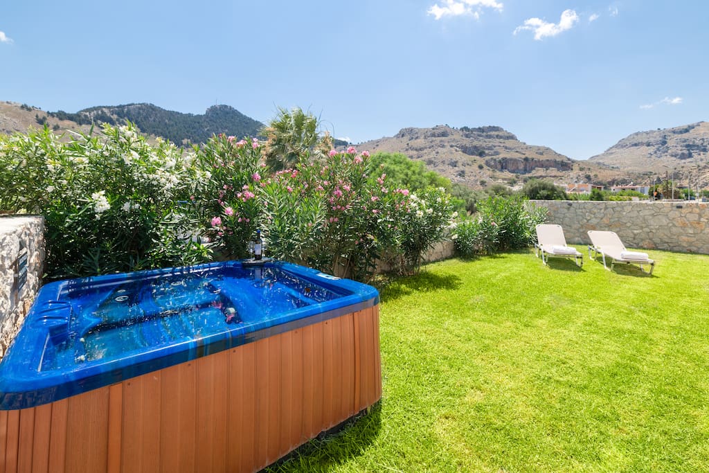 Private garden with mountain views, jacuzzi and sun beds.